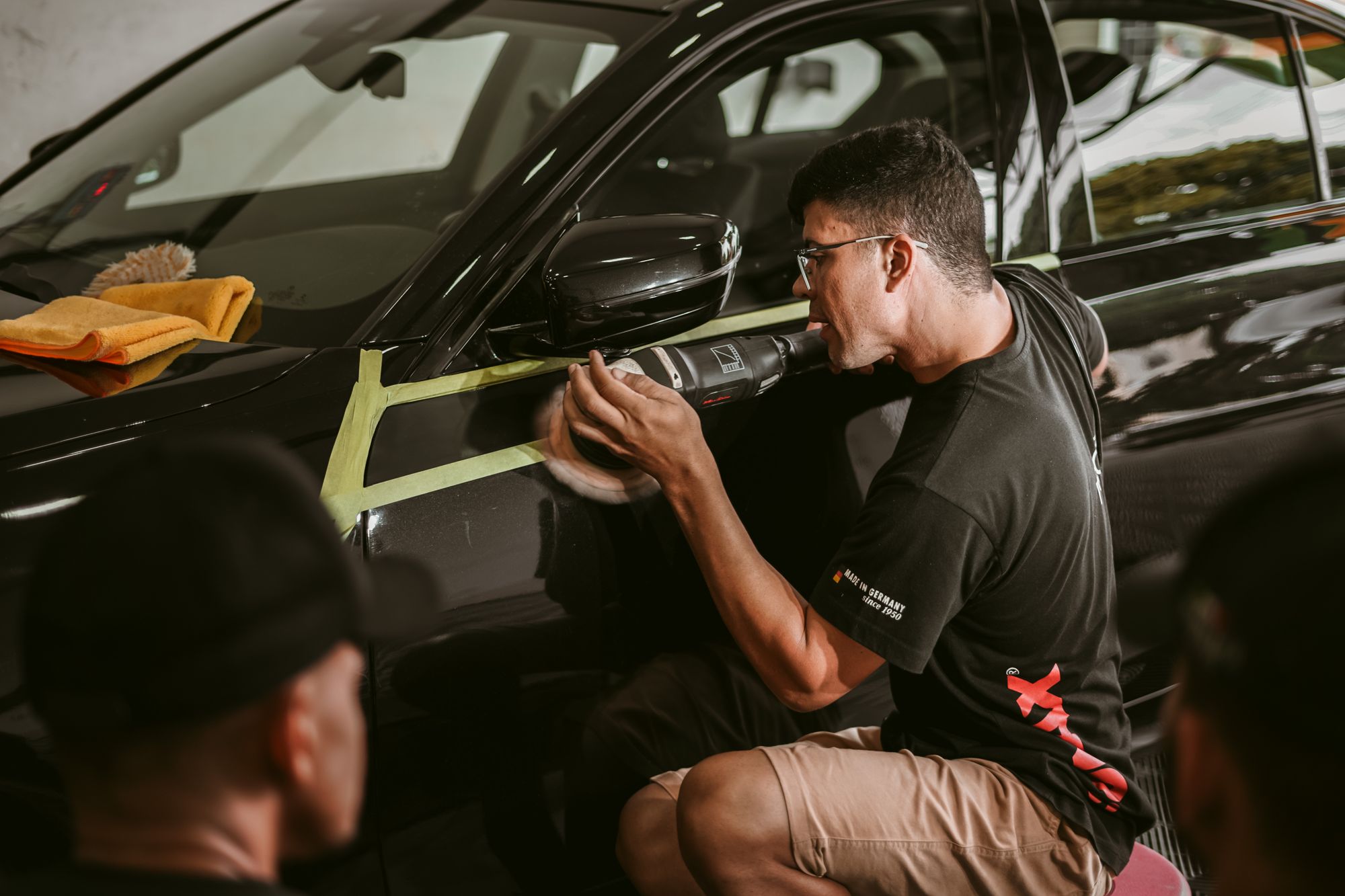 A car-care professional attending to a vehicle